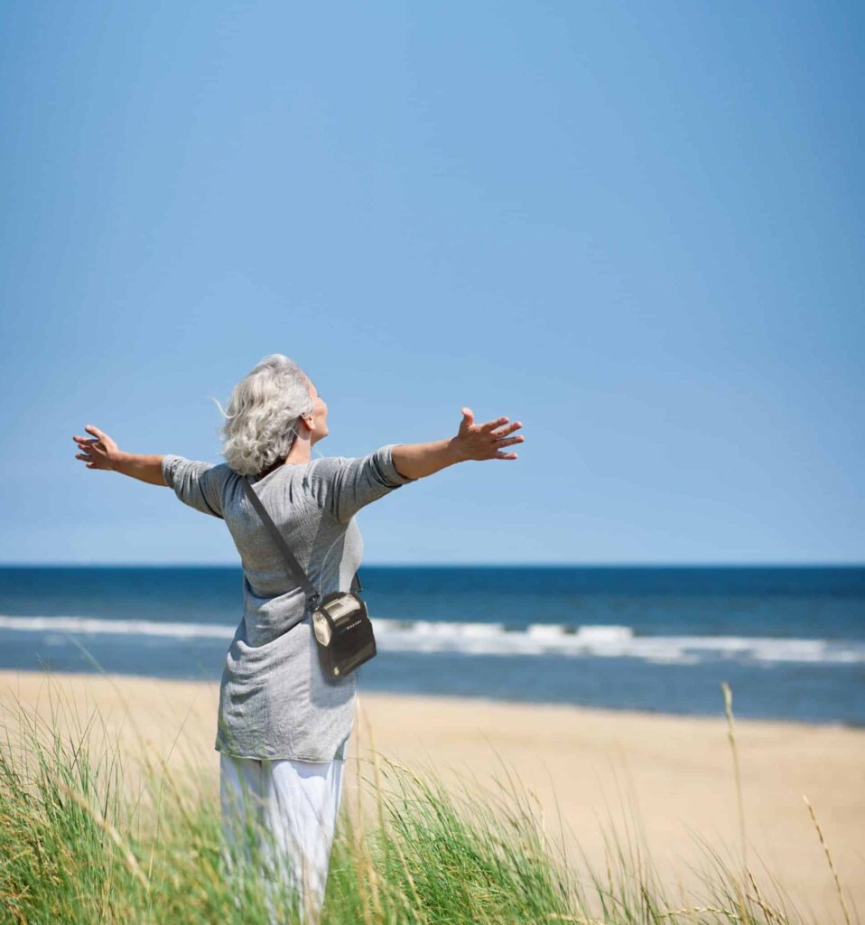 Inogen One G4 over shoulder of lady on beach