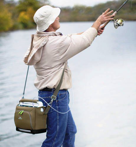 simplygo oxygen concentrator worn over shoulder while man is fishing