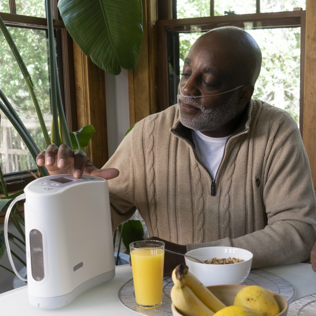 Oxlife Liberty portable oxygen concentrator sitting on table